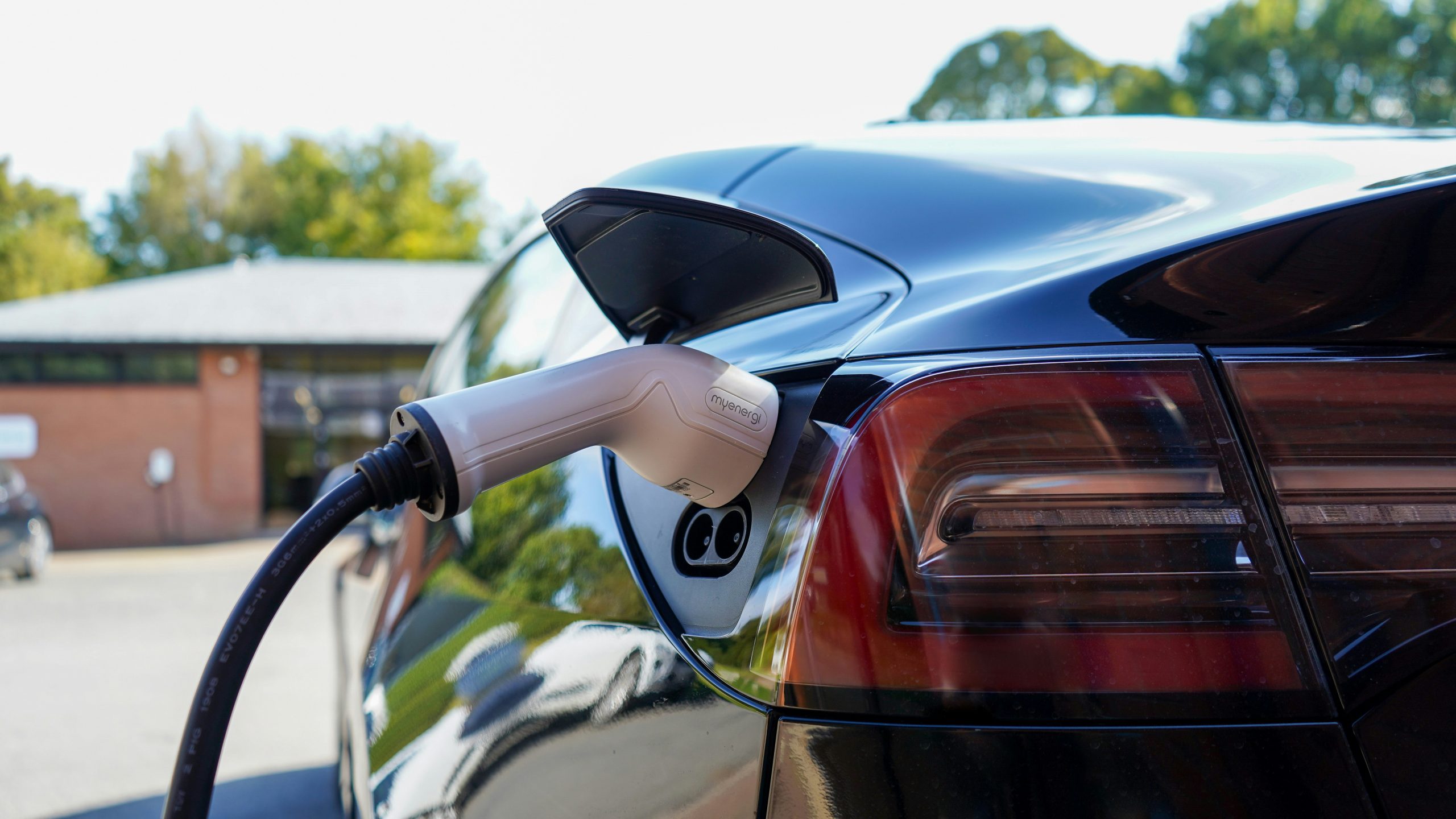 A plug connected to an electric vehicle's charging port.