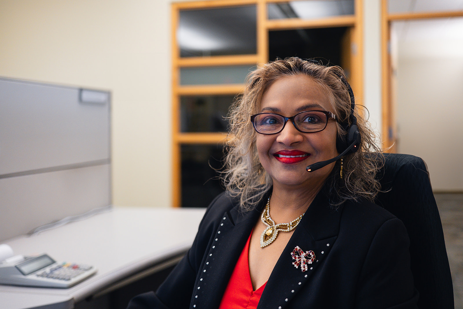 A GrandBridge Customer Service Representative in the office ready to respond to a customer's call.