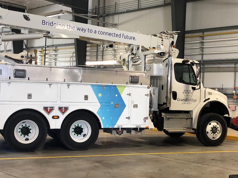 A GrandBridge Energy utility vehicle parked inside of a warehouse