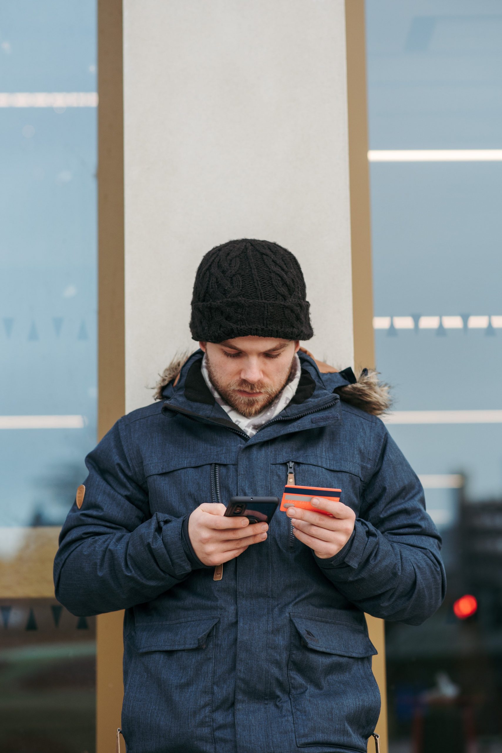 A man paying by credit card on his phone.