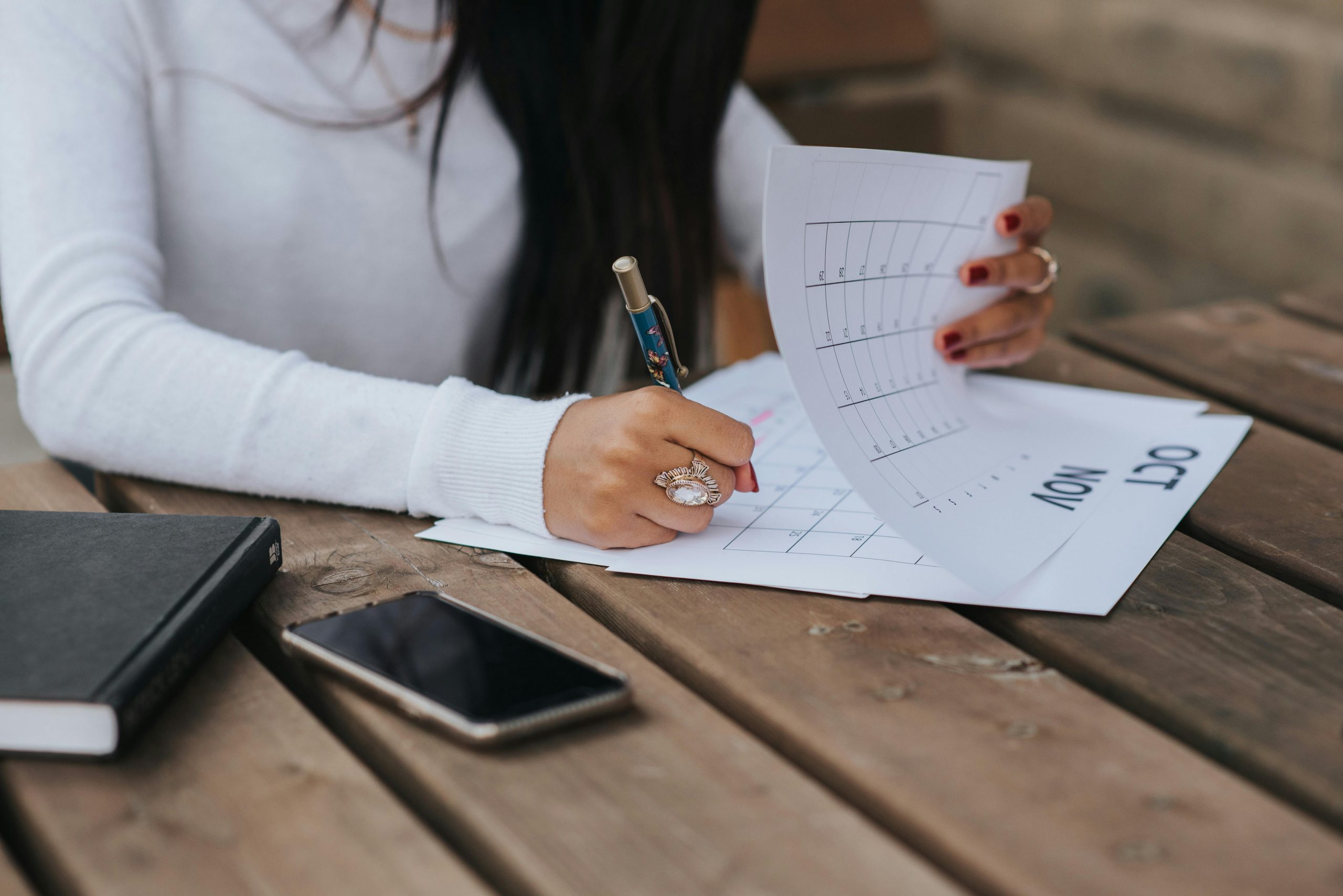 Women writing down a date in her calendar