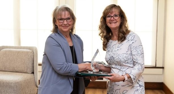 President and CEO Sarah Hughes presenting Kim Fowler with an award at the 30th annual YWCA Cambridge Women of Distinction Awards.