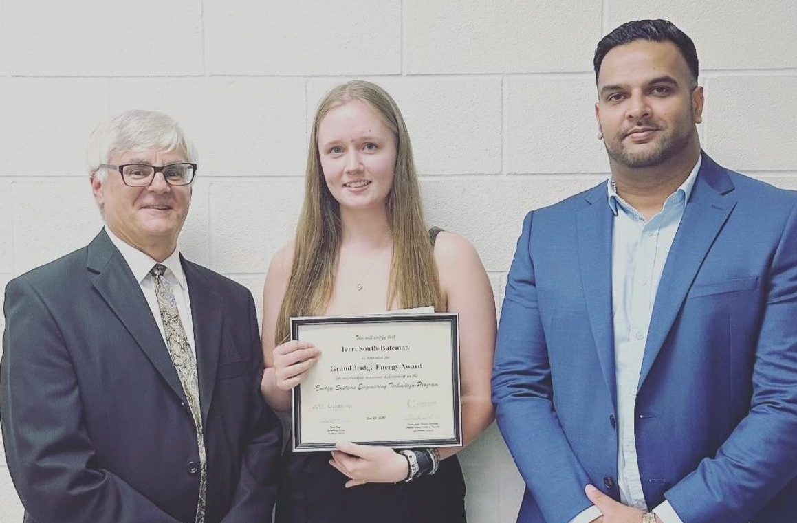 Umar Waqas, Vice President of Engineering and Continuous Improvement standing with a student who received an award for their excellence in education.