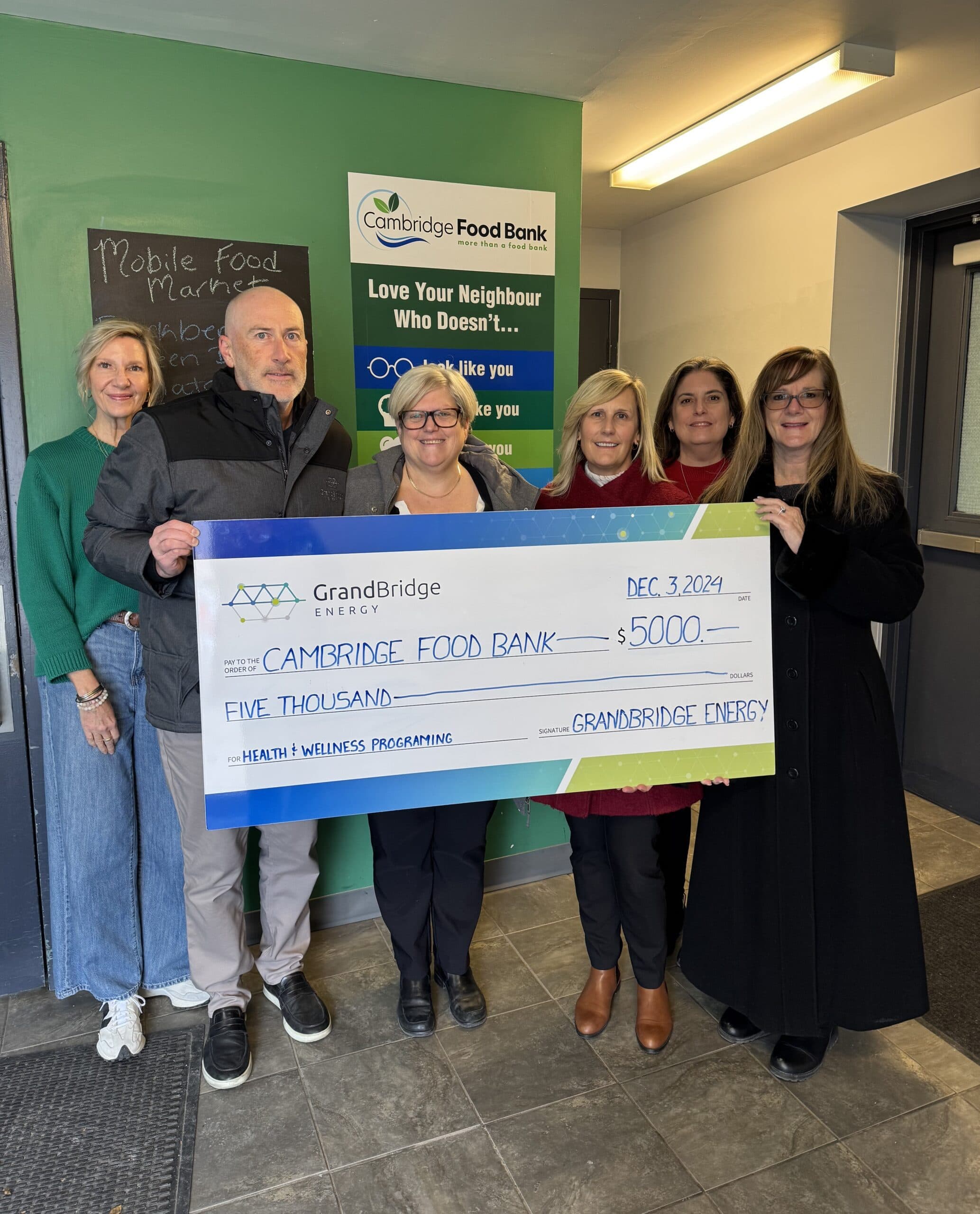 Group of people presenting a cheque.