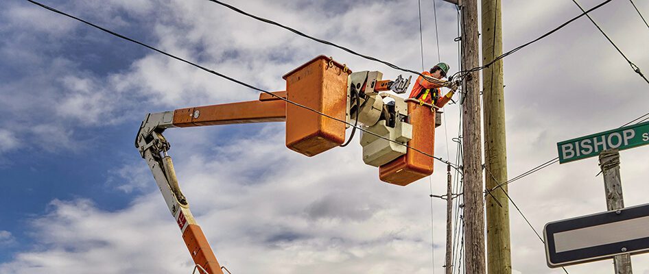 Man in bucket truck fixing powerline