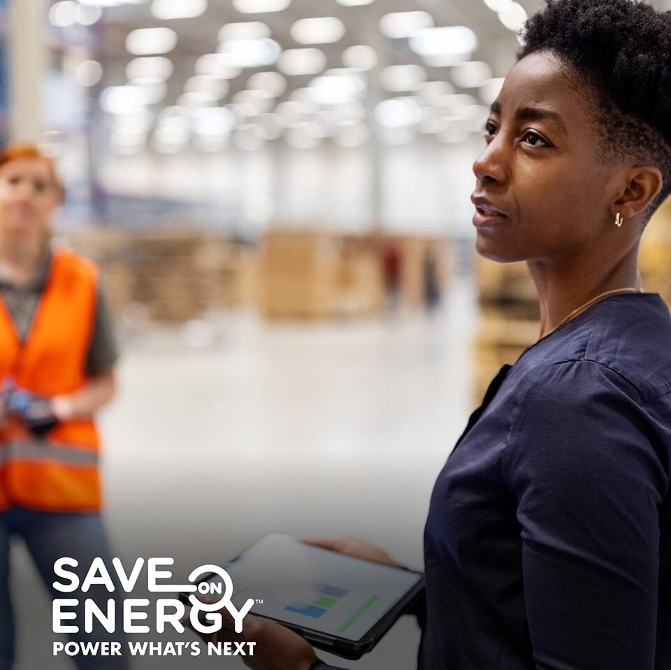 Woman examines warehouse for energy saving measures
