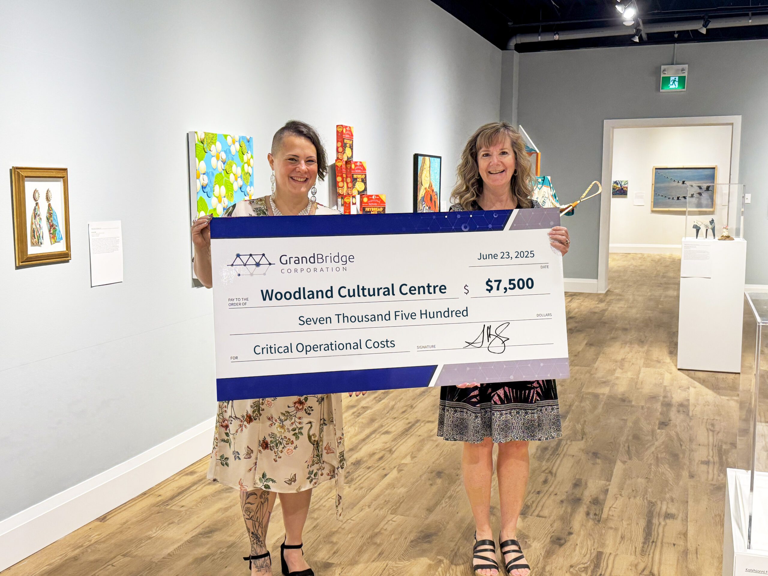 Sarah Hughes presents GrandBridge’s $7,500 donation to Heather George, Executive Director of Woodland Cultural Centre.