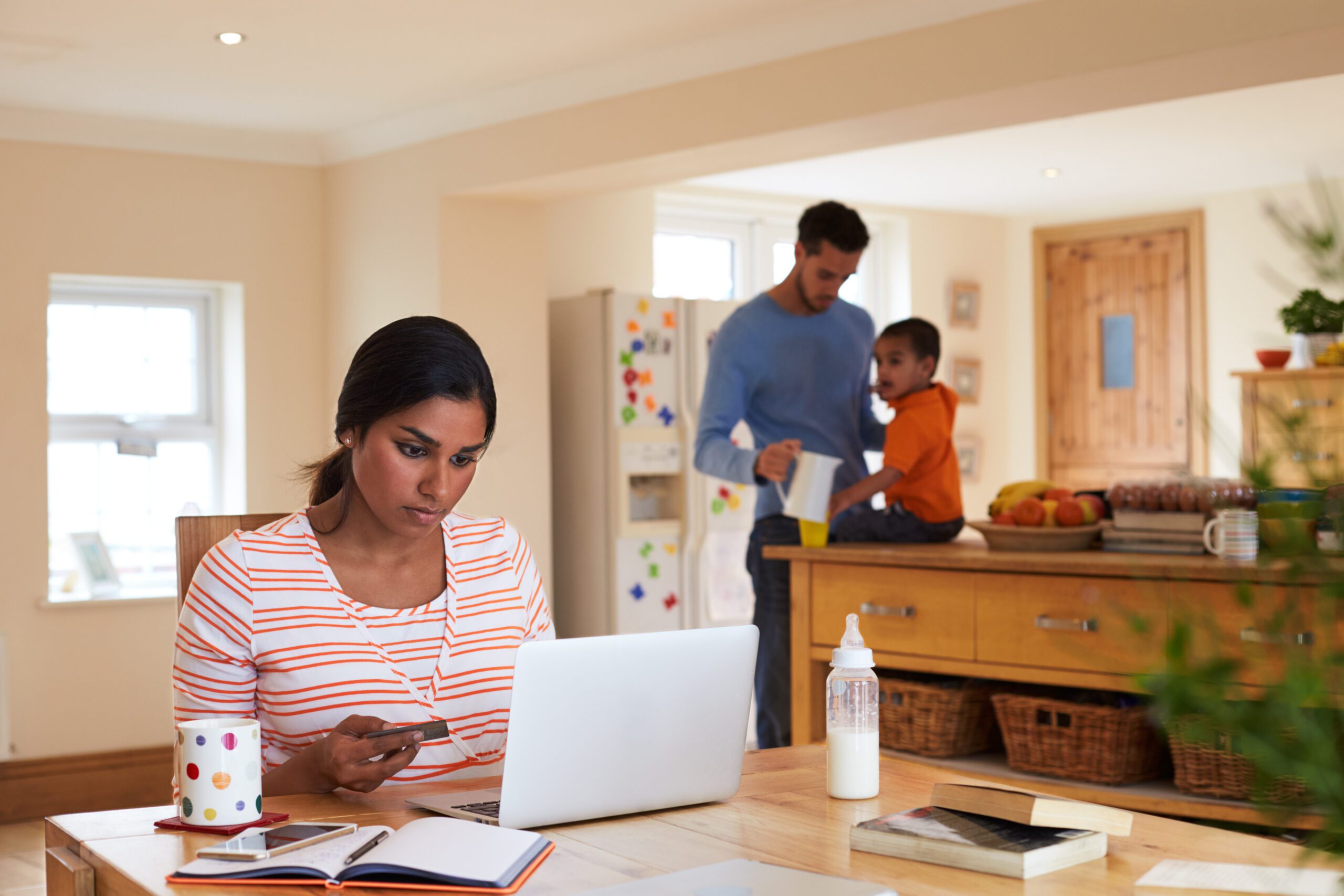 Homeowner checking online resources on her laptop