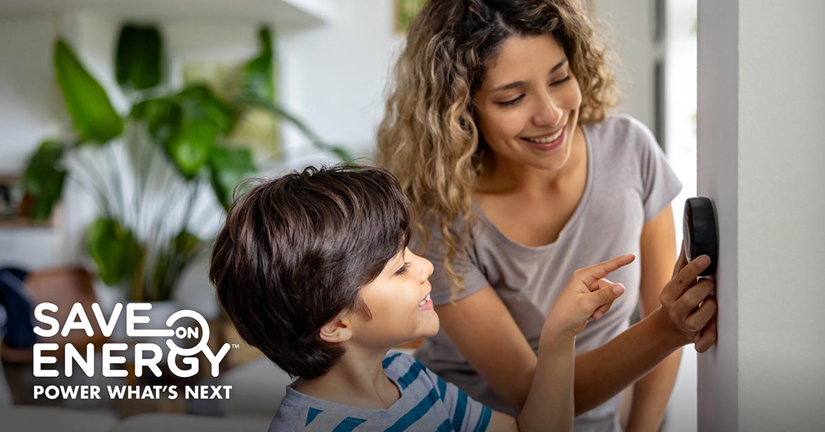 Woman and child check their thermostat