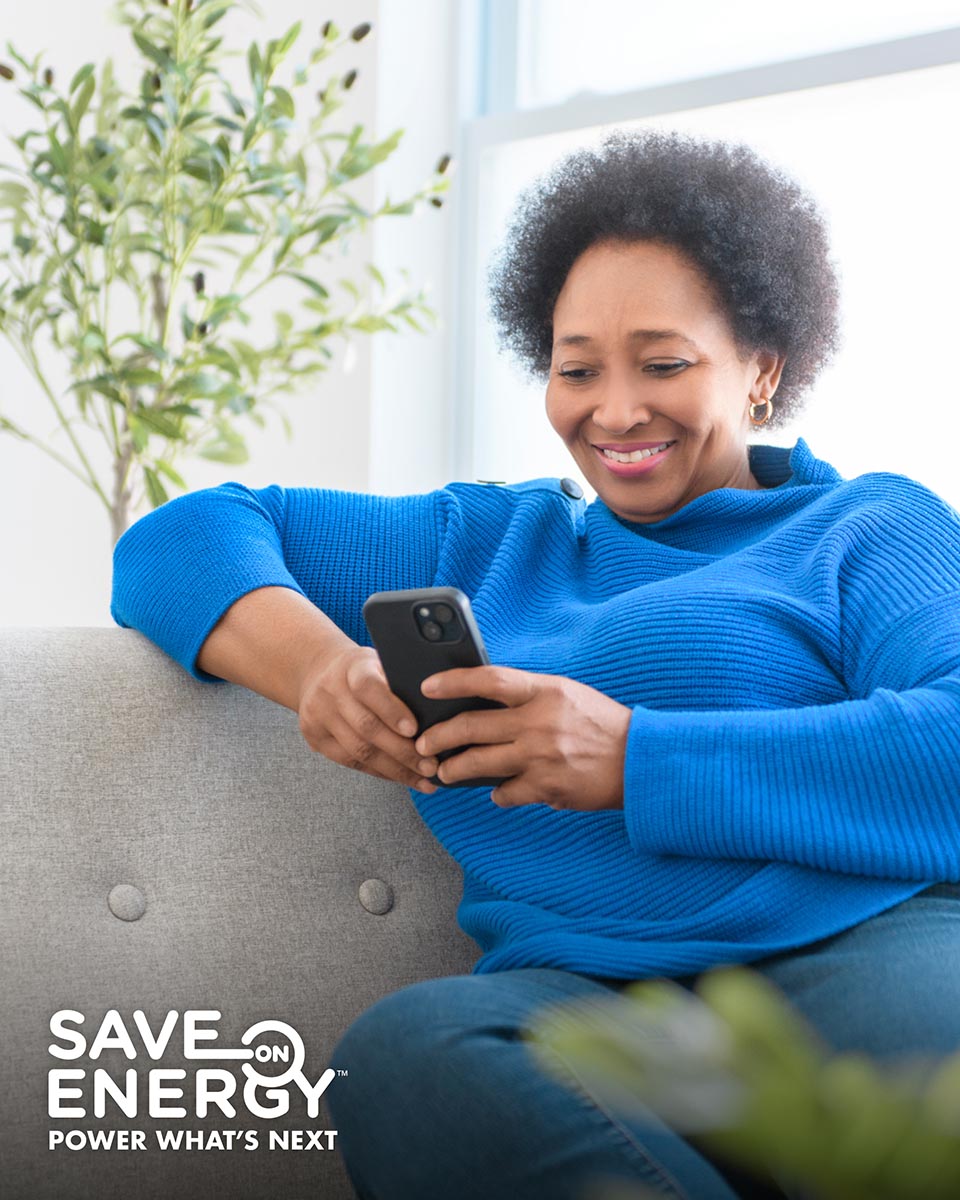 Woman smiling looking at her mobile phone