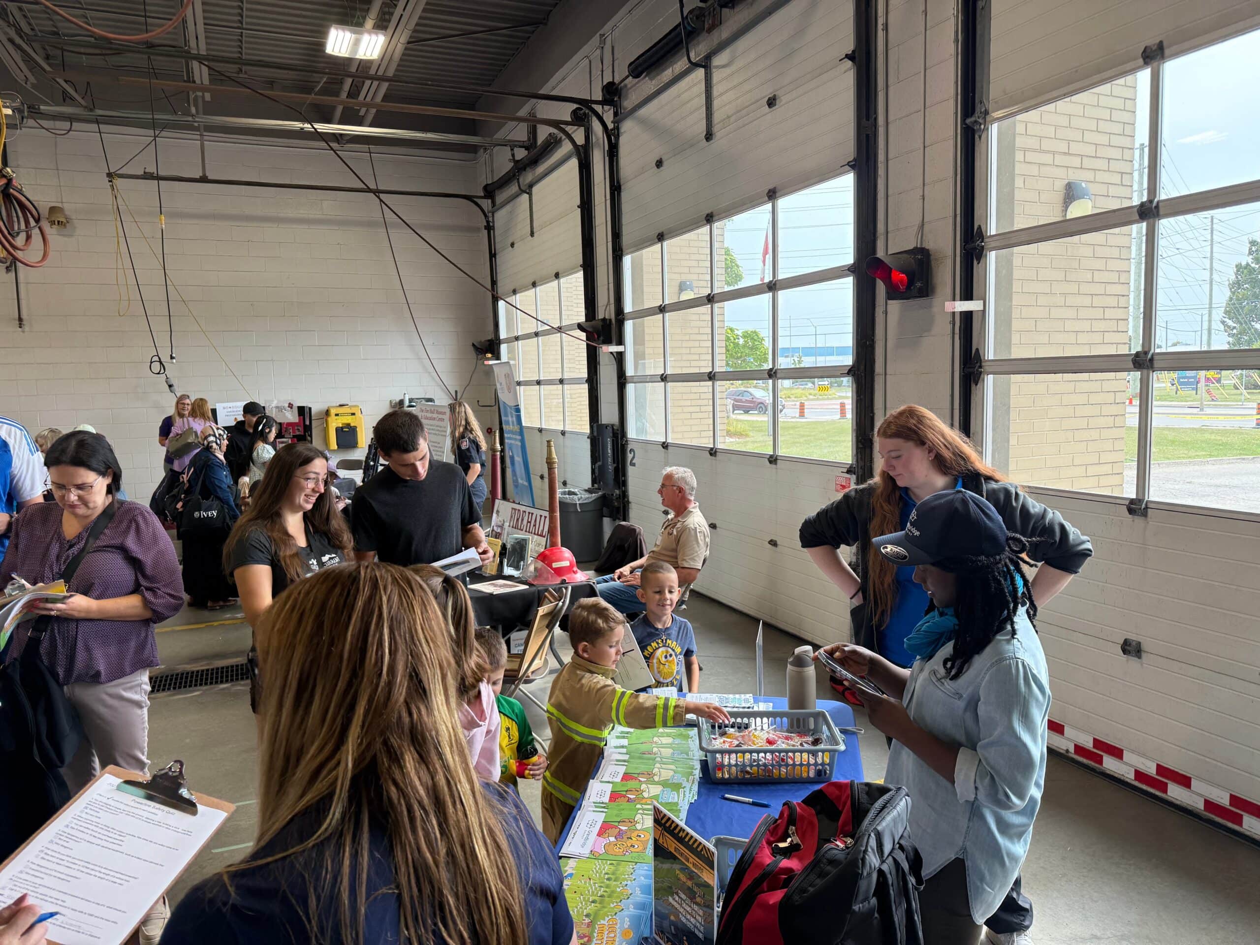 Children visiting a company booth during an open house at the fire station in Cambridge.