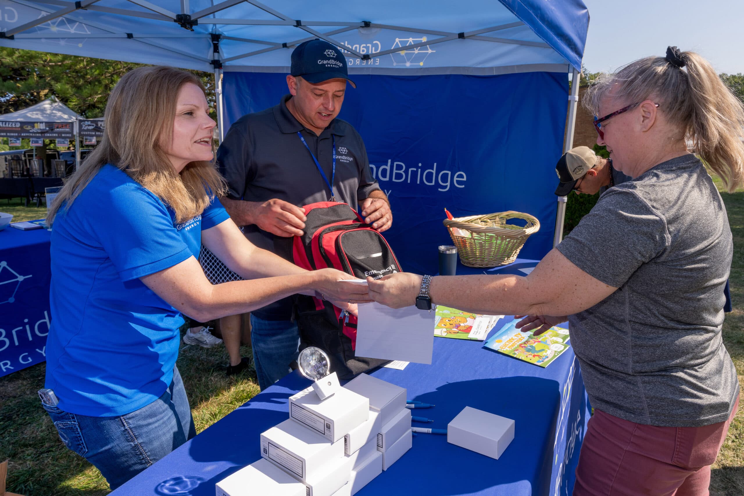 Employees speaking with Applefest attendees.