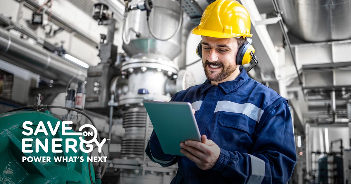 Man checking the energy efficiency of factory equipment.