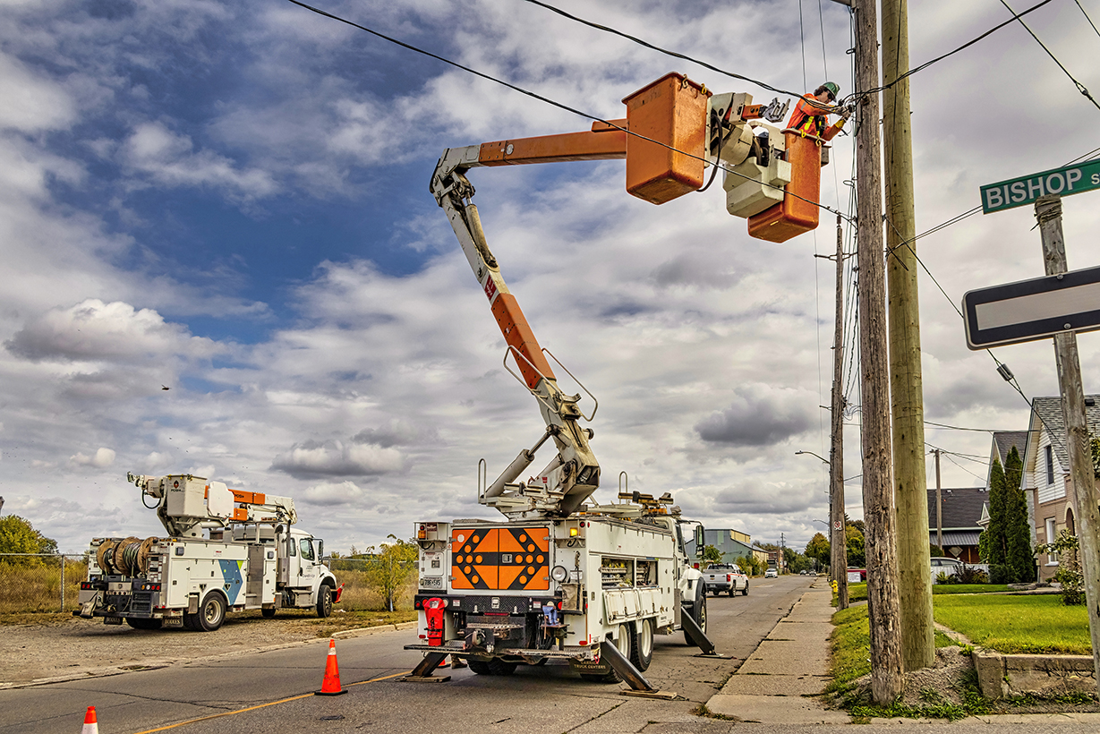 Powerline worker repairing a service on the powerline.
